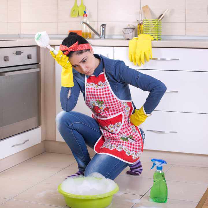 Woman Scrubbing Tile Floor